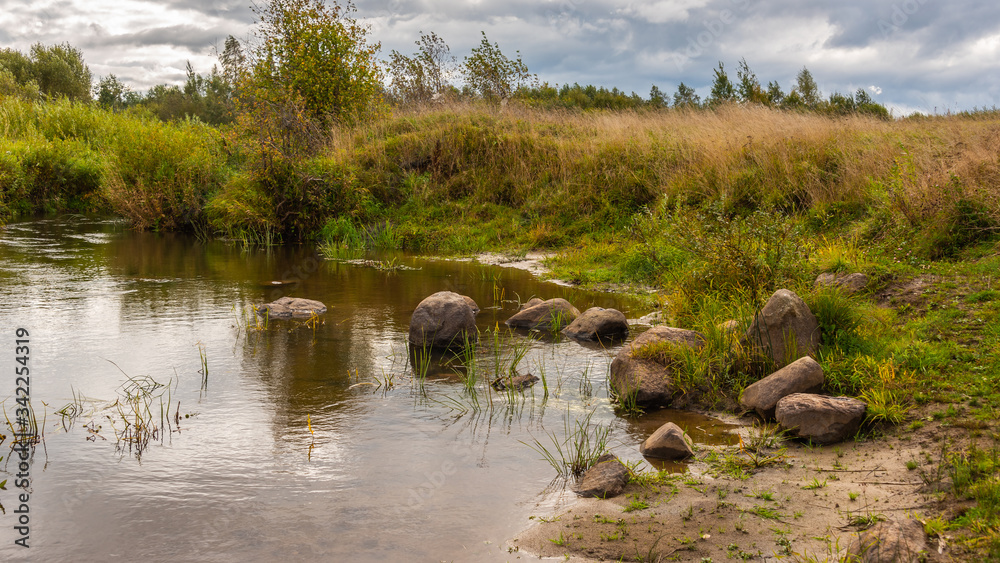 Autumn landscape with a river on a cloudy day Autumn landscape with a river on a cloudy day