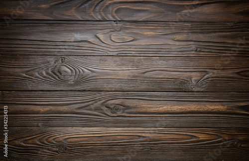 Natural dark wooden textured background of flat layed planks with weathered vintage oiled surface