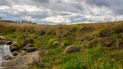 Autumn landscape with a river on a cloudy day