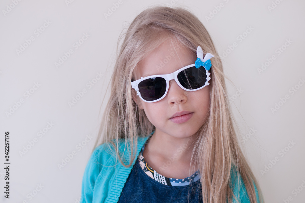 Naklejka premium Portrait of a blonde girl in dark glasses