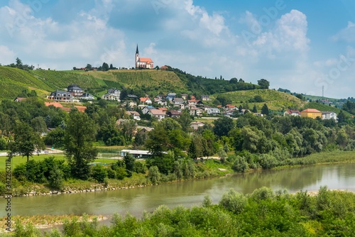 Summer rural landscape with the river Drava and Church of Sv. Marija in Malecnik near Maribor, Slovenia