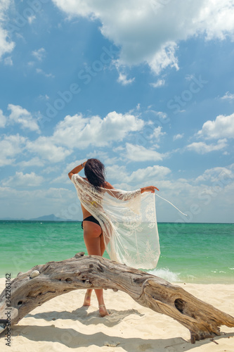 Young woman on the white sand beach
