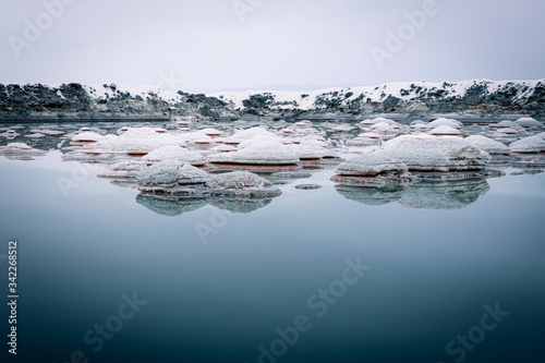 Salt reservoir pond with naturally forming salt crystals in the middle and salty water around after rain in the lake of Tuz in Turkey. photo