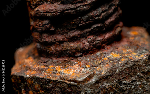 Rusted screw closeup view on black background