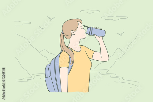 Travelling, tourism, nature, hiking concept. Young thirsty woman hiker tourist with backpack standing in mountain valley and drinking water. Vacation trip with active recreation and extreme lifestyle.