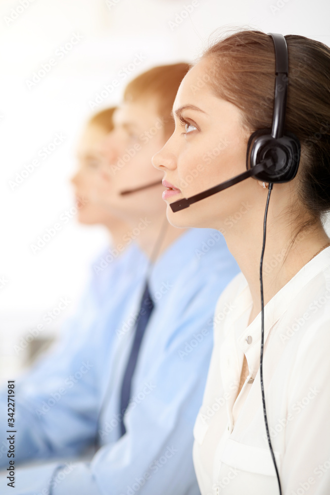 Call center. Diverse customer service operators in headsets at work in office. Business concept Call center. Diverse customer service operators in headsets at work in office. Business concept