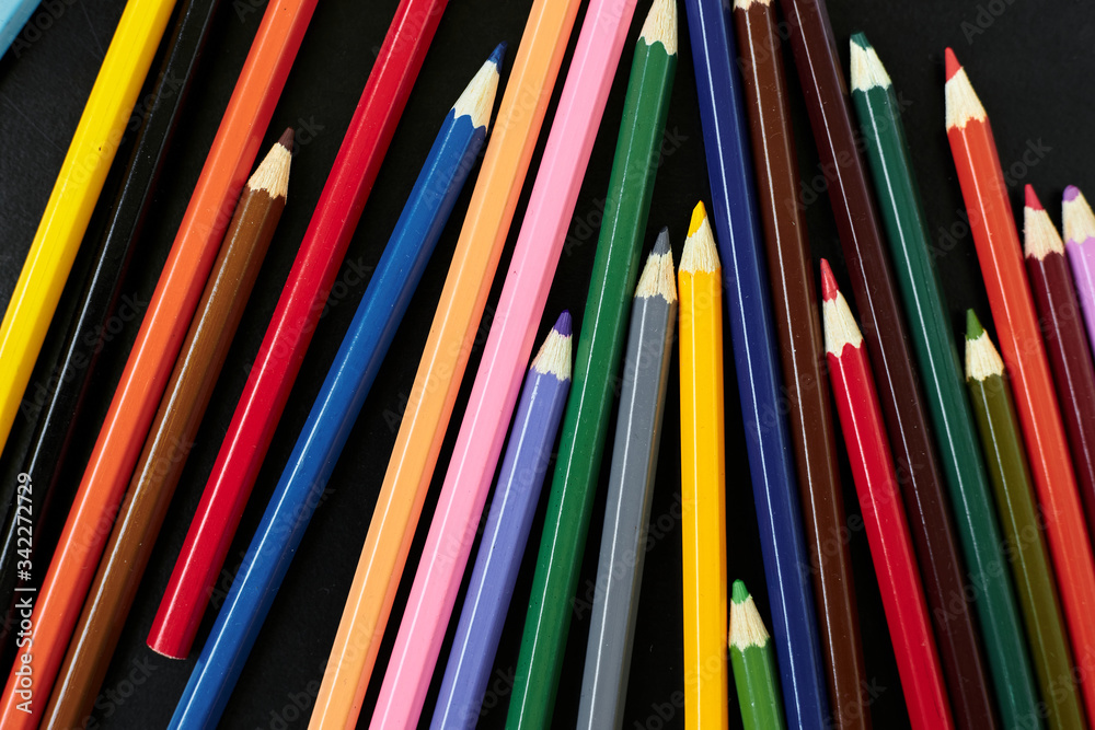 A pencil next to a book shelf A pencil next to a book shelf