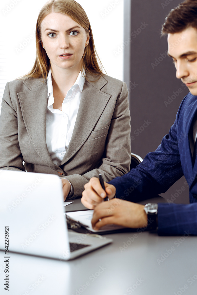 Business people using laptop pc while discussing project in office. Successful meeting and negotiation concepts Business people using laptop pc while discussing project in office. Successful meeting and negotiation concepts