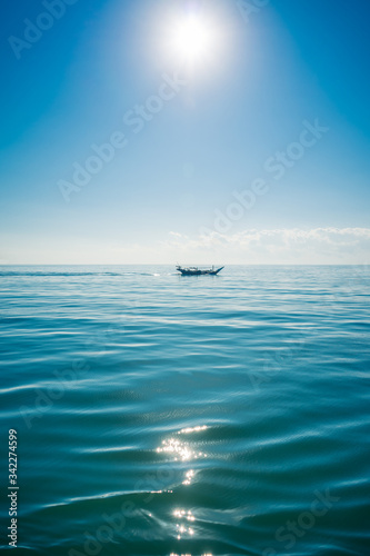 Fototapeta Naklejka Na Ścianę i Meble -  Boat sailing in the sun through the Arabigo Sea in the direction of Masirah Island, Oman