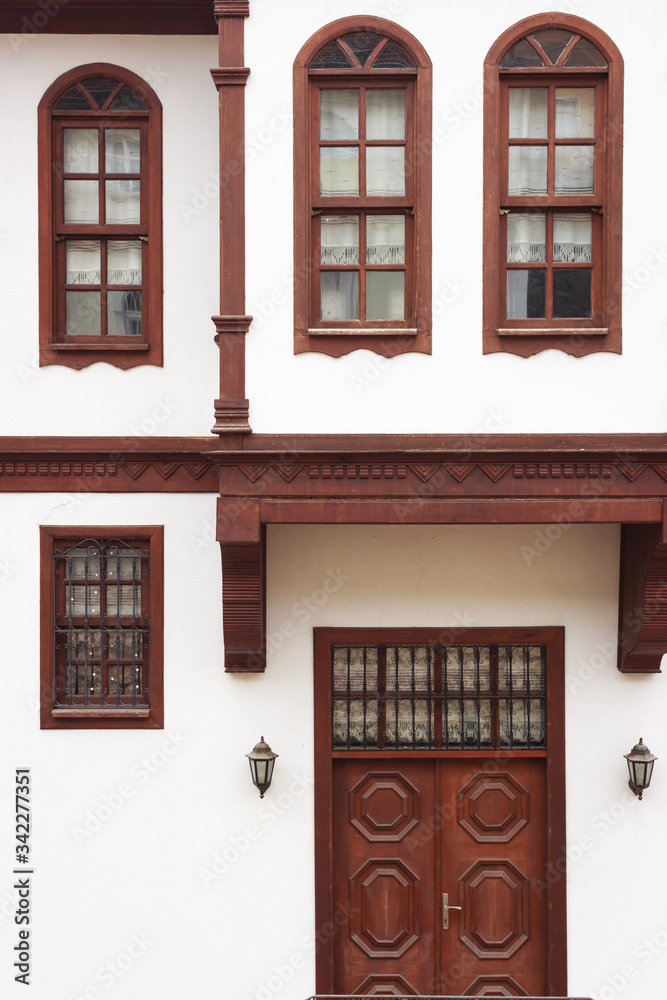 Old traditional Turkish wooden house has brown windows and door with white walls. Old traditional Turkish wooden house has brown windows and door with white walls.