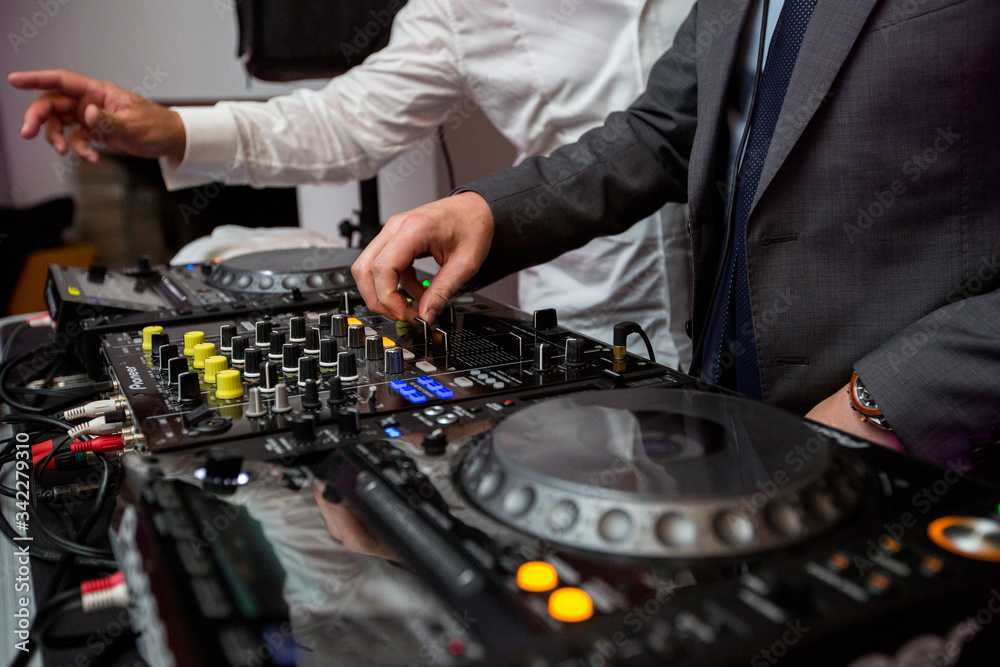 DJ playing music at mixer DJ playing music at mixer
