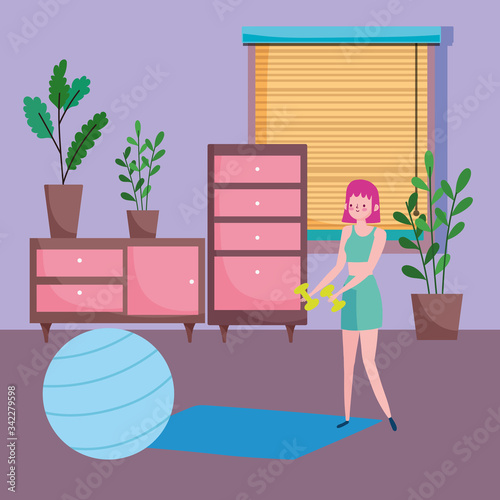 young woman with dumbbells and fitball mat in the room, exercises at home