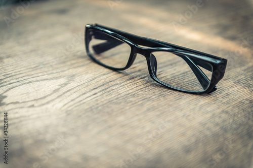 closeup of eye glasses on wooden floor