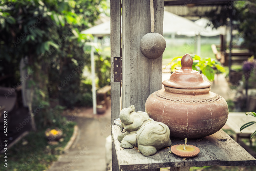baked clay on wood table, traditional of Thailand baked clay on wood table, traditional of Thailand