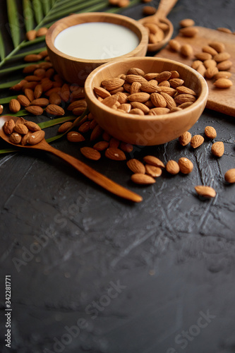 Close up of Almonds in wooden bowl and almond milk