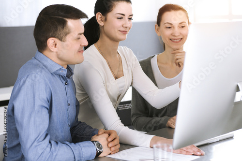 Group of business people discussing questions at meeting in modern office. Headshot at negotiation or workplace. Teamwork, partnership and business concept