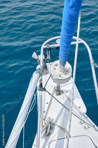 Bow of the sail boat with anchor rope. Sailing at summer sunny day. Yachting concept and sea background