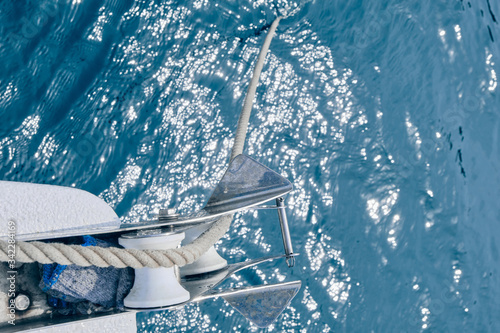 Bow of the sail boat with anchor rope. Sailing at summer sunny day. Yachting concept and sea background