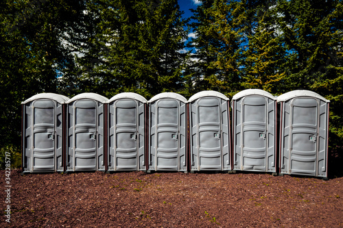 Outhouses in a row, outdoors. photo