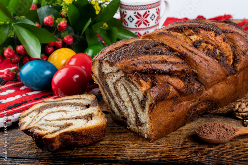 Traditional Romanian Easter table with cozonac and pasca meaning Sweetbread and Matzo an unleavened flatbread that is part of Jewish cuisine and forms an integral element of the Passover. Happy Easter photo