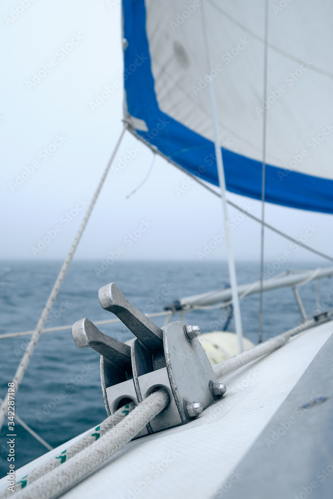 Fototapeta premium closeup white line in stopper of sailboat at foggy summer day. Yachting concept and sea background