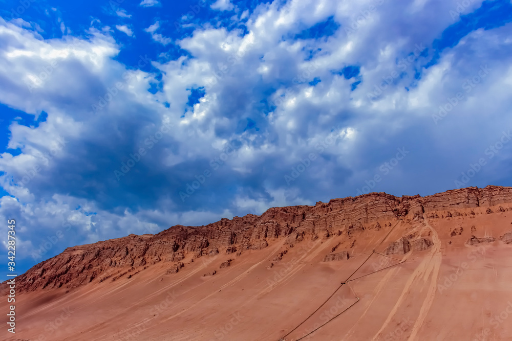 Striking gullies at Flaming Mountains caused by erosion of the red sandstone bedrock Striking gullies at Flaming Mountains caused by erosion of the red sandstone bedrock