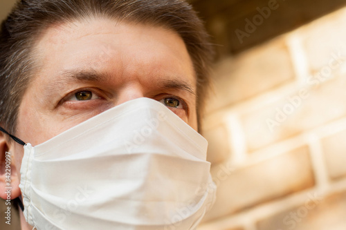 A girl wearing handmade cotton face mask to prevent spreading of the viruses. Coronavirus and COVID-19 ConceptA man wearing handmade cotton face mask to prevent spreading of the viruses. Coronavirus a photo