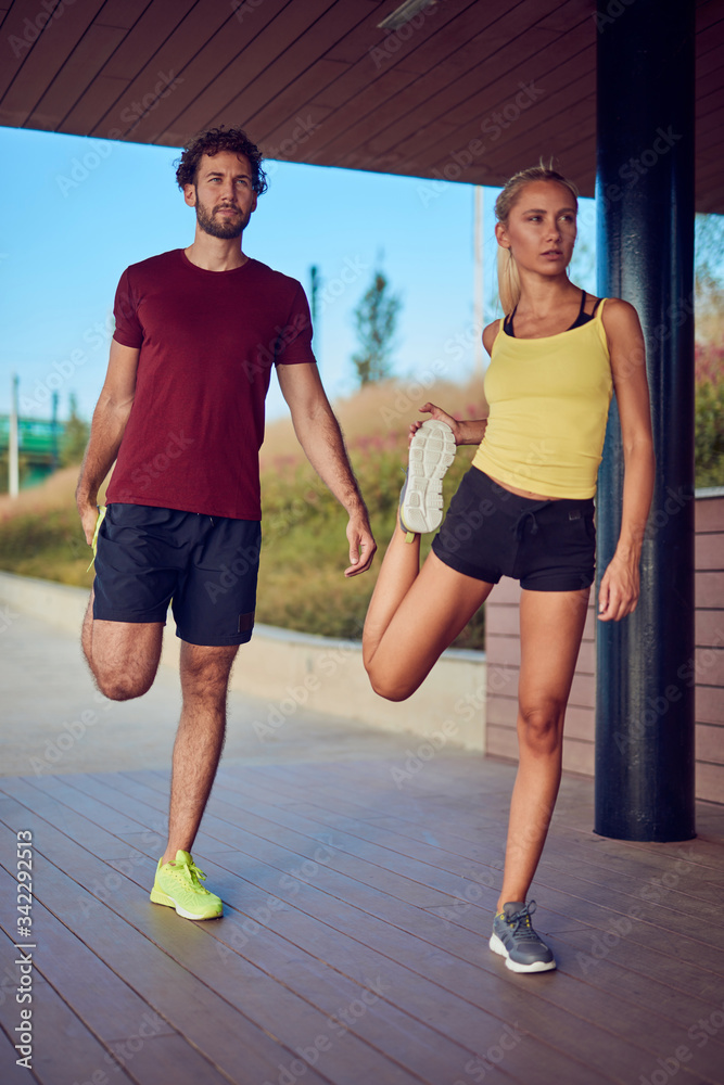 Modern woman and man jogging / exercising in urban surroundings near the river. Modern woman and man jogging / exercising in urban surroundings near the river.