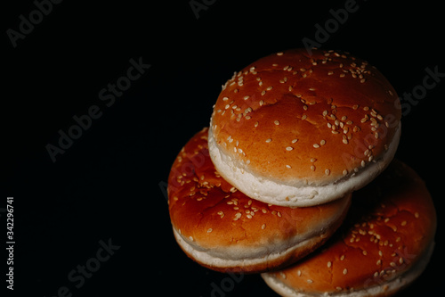 Wallpaper Mural Three hamburger buns on a black background Torontodigital.ca