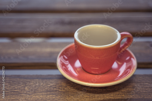 Colorful ceramic cup on wooden table for espresso