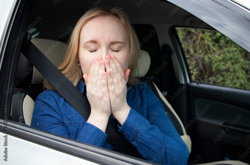 Nausea during a car trip. A blonde woman suffers from The