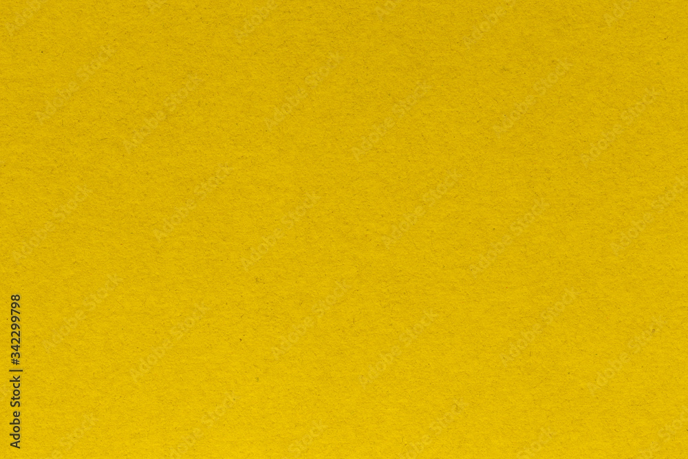 Close-up texture of yellow crepe corrugated blotting paper for DIY. Concept of choice. Soft focus, high contrast, horizontal background shot Close-up texture of yellow crepe corrugated blotting paper for DIY. Concept of choice. Soft focus, high contrast, horizontal background shot