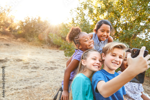 Group Of Multi-Cultural Children Posing For Selfie With Friends In Countryside Together