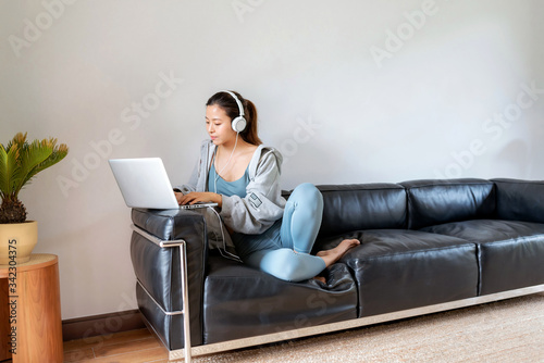 A young Asian woman in a sports office at home