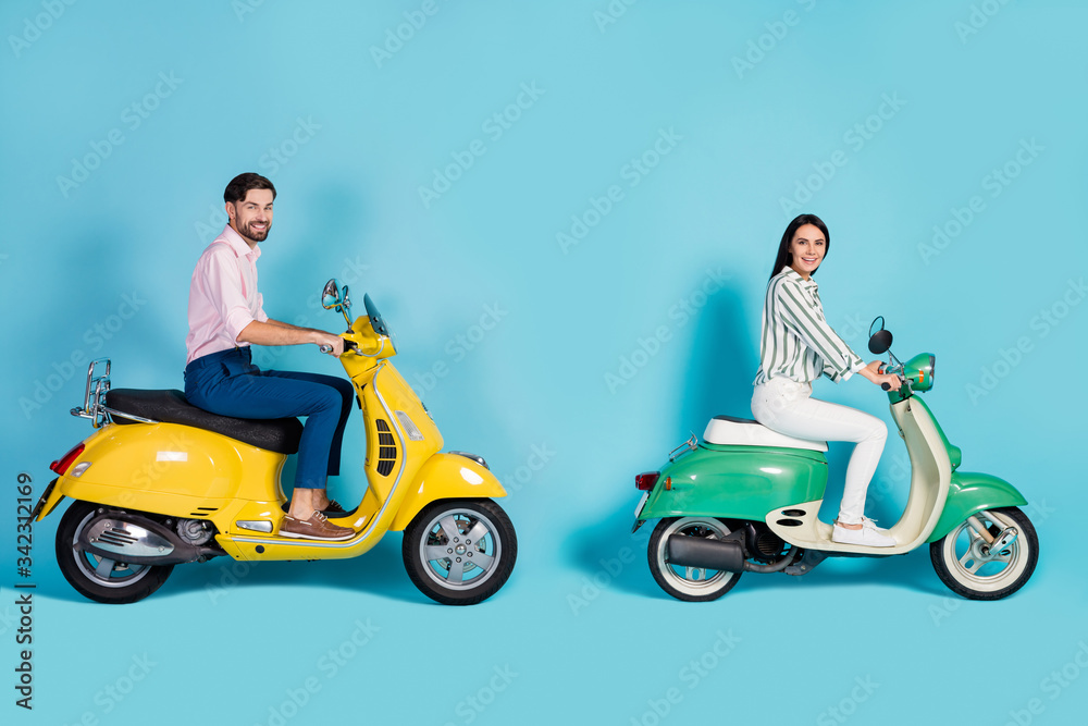Full length profile side photo positive wife husband bikers drive yellow green motorcycle enjoy street trip wear white striped shirt pink pants trousers isolated blue color background Full length profile side photo positive wife husband bikers drive yellow green motorcycle enjoy street trip wear white striped shirt pink pants trousers isolated blue color background