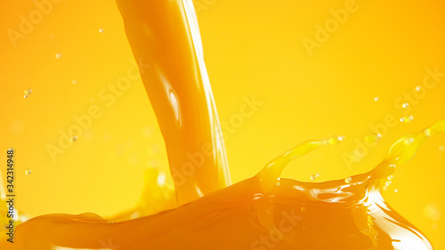 Orange juice splash on coloured background photo