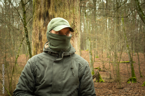 Man with covered face looking into the forest © darekb22