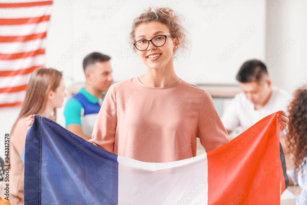 Female student with flag of France at language school Female student with flag of France at language school