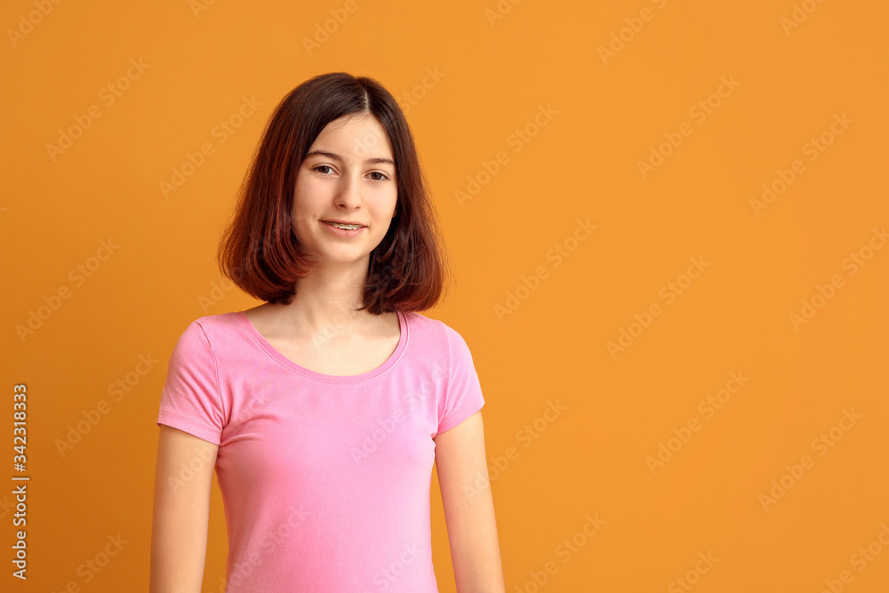 Teenage girl with dental braces on color background Teenage girl with dental braces on color background