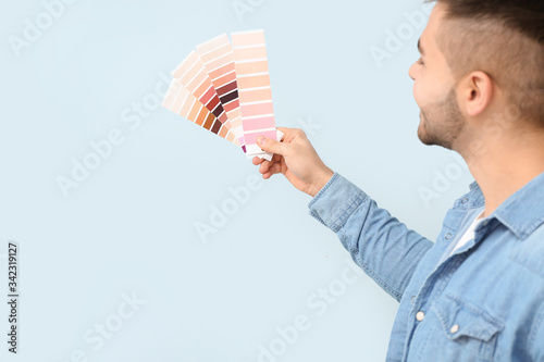 Man holding color swatch pa...