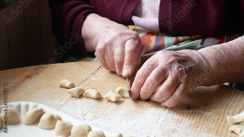 hands of elderly woman making homemade pasta orecchiette. typical food of southern Italy
