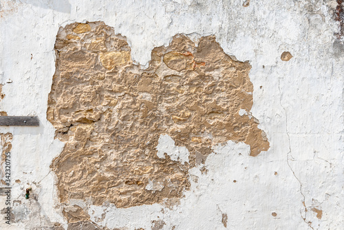 Old wall with cracked plaster or lime. Background texture