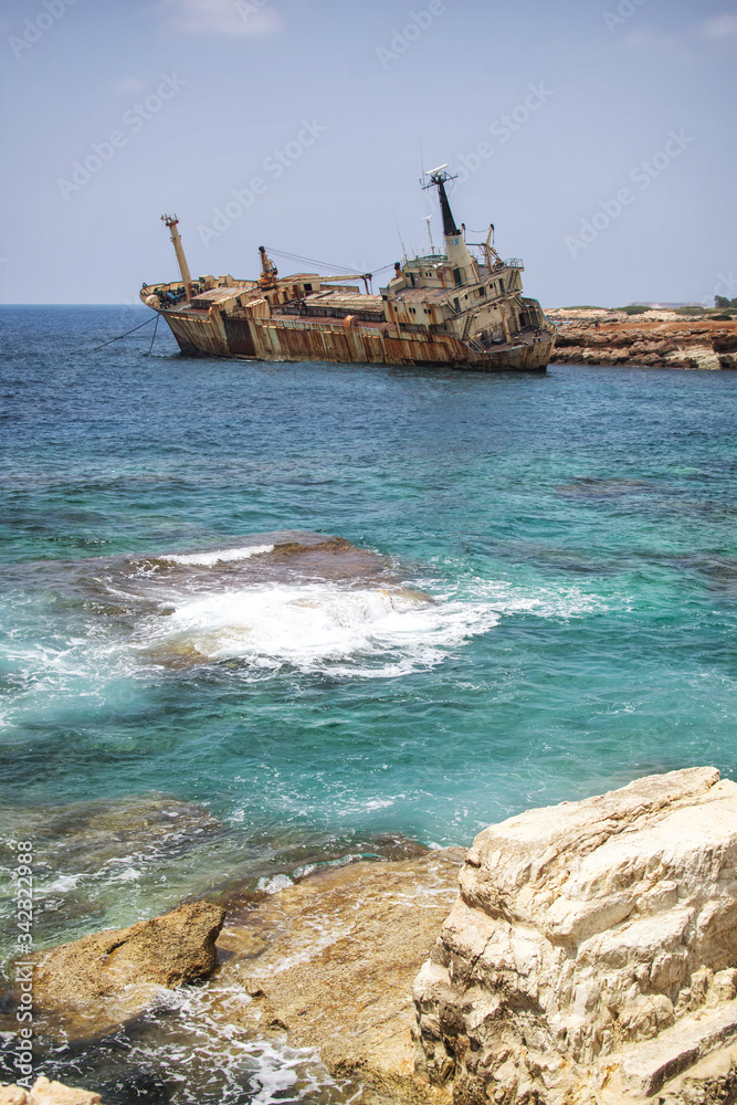 Paphos. Shipwreck. The ship crashed on the coastal rocks at the shore of the Mediterranean sea. Tourist attractions of Cyprus.