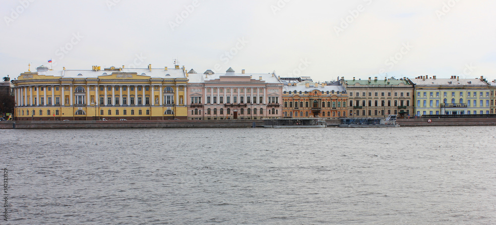English embankment architecture buildings in Saint Petersburg, Russia. English quay is a street along the left bank of the Neva river in St Petersburg city. Buildings facades on gloomy spring day