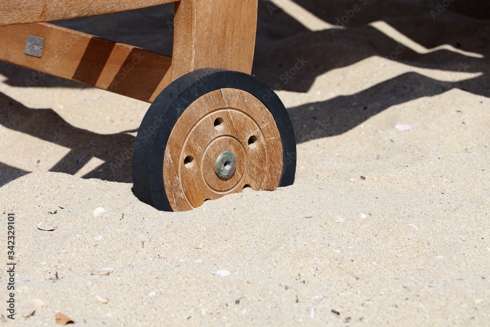 Wheel of Wooden of Sun Lounger on the sand