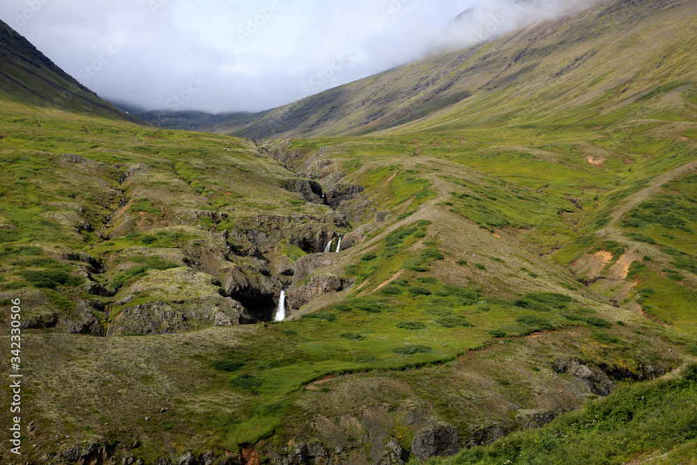 Iceland - August 29, 2017: A stream and mountains along the Ring Road, Iceland, Europe