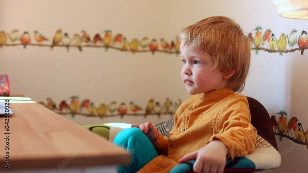 Little male child spending time online with laptop on modern background. Children education. Happy family. Traveling business people. Technology. Innovation. Gaming for kids. Trendy lifestyle.