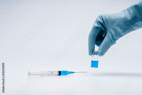 Doctor with a syringe and a vaccine with latex gloves. Concept medicine and vaccine for pandemic and vaccination.