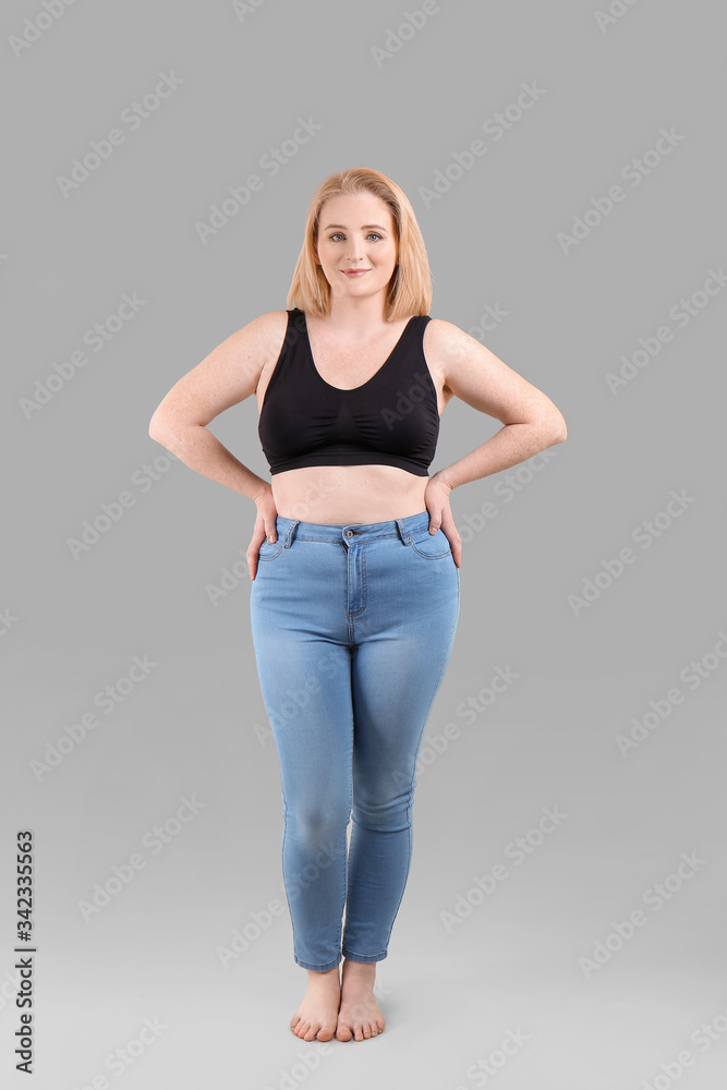 Overweight woman on grey background Overweight woman on grey background