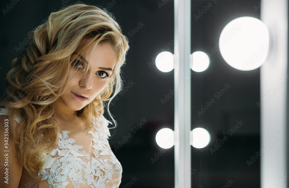  Portrait of a young beautiful blond woman. Modern fashion beautiful makeup and hairstyle. 